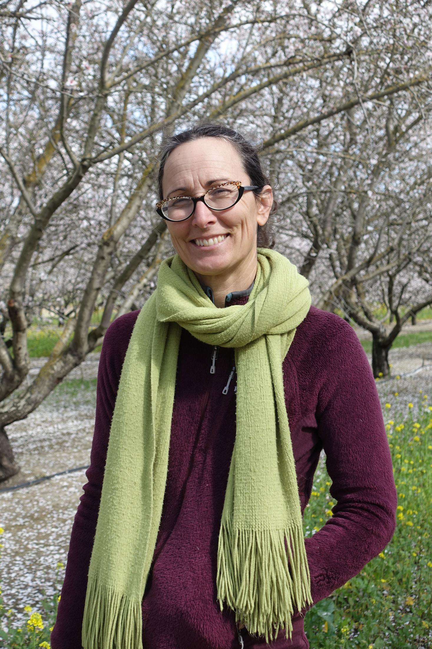 Christine Gemperle stands in her almond orchard